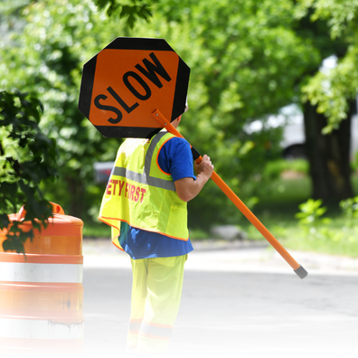 Image of a Maintenance Worker Holding a Slow Sign