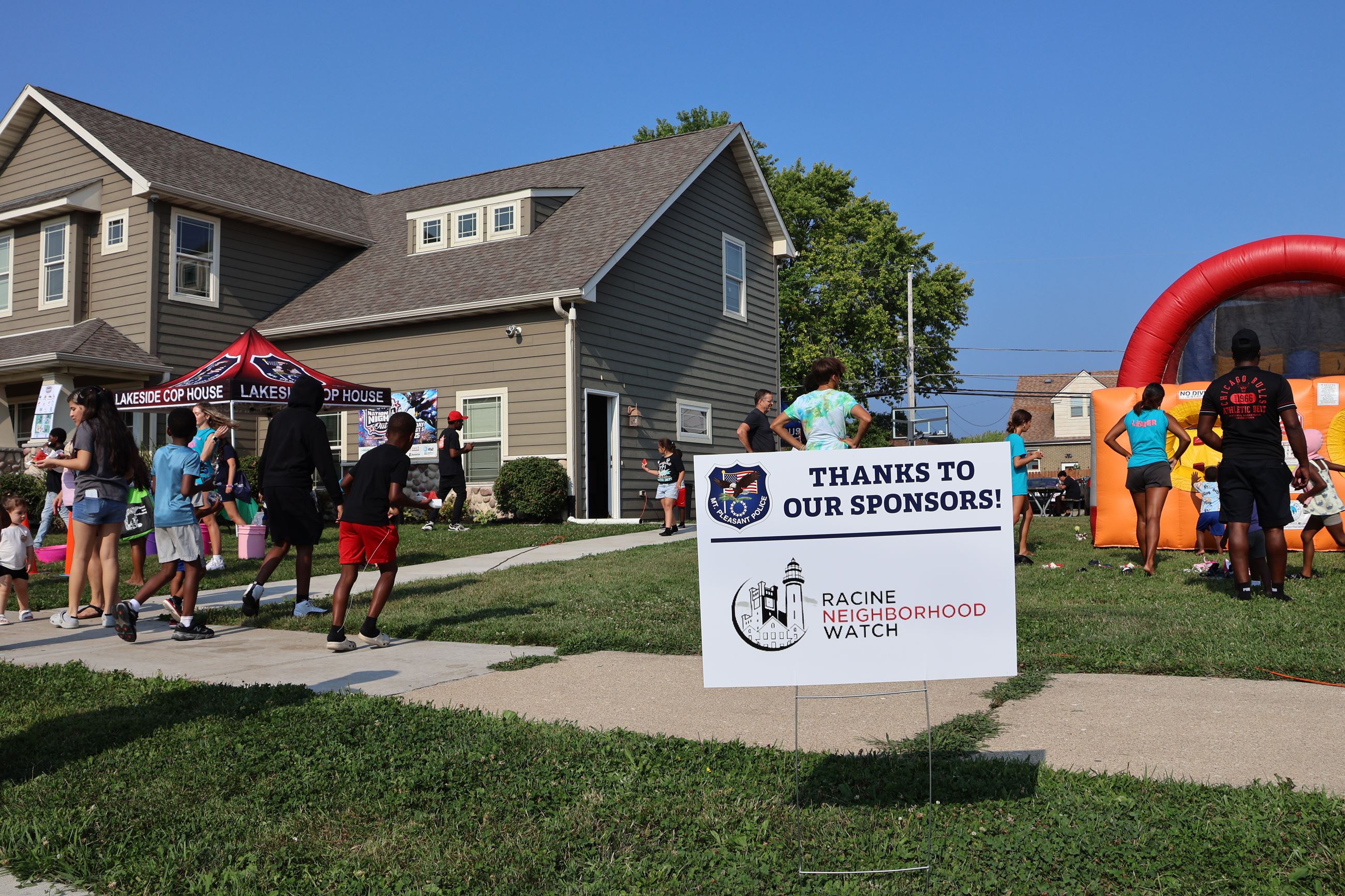 Children and adults enjoy the National Night Out event outside the Lakeside COP House