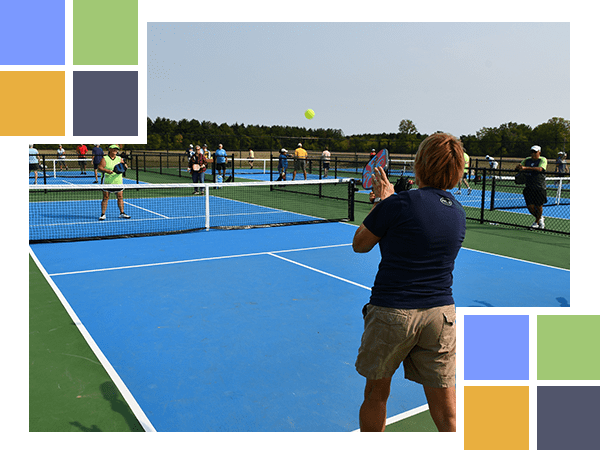 adults playing pickleball on courts